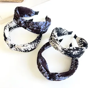 Detailed macro shot of tie-dye knotted wide fabric headbands in blue and white