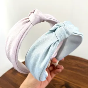 Gedetailleerd overzicht van de glanzende geknoopte stoffen hoofdbanden in roze en blauw