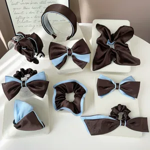 Detailed view of brown and blue satin hair accessories set with bows and scrunchies