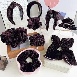 Collection of elegant deep plum velvet hair accessories including headbands and scrunchies