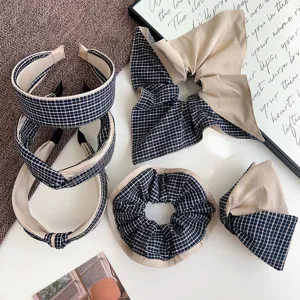 Detailed view of blue plaid hair accessories set including headbands and scrunchie.