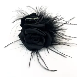 Detailed view of an elegant black handmade ostrich feather rose motif hair claw clip.