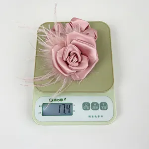 Weight measurement detail showing pink satin camellia hair scrunchie at 17.4 grams