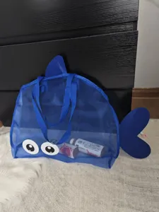 Blue mesh beach bag with cute big eyes, large capacity travel tote for kids toys and swim gear.