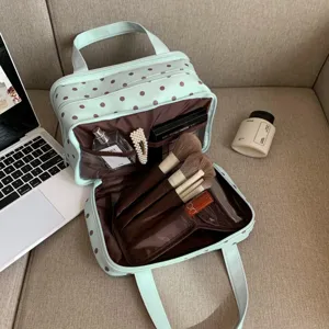 Large capacity polka dot cosmetic bag with multi-layer compartments for travel and daily use.
