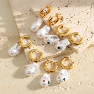 Detailed shot of vintage gold-plated Baroque pearl hoop earrings with colorful crystals