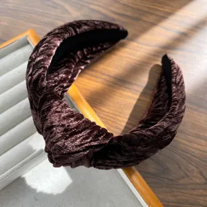 Close-up detail showing the luxurious knotted texture of a brown velvet padded headband