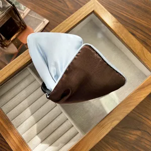 Detailed view of an elegant two-tone blue and brown satin bow headband.