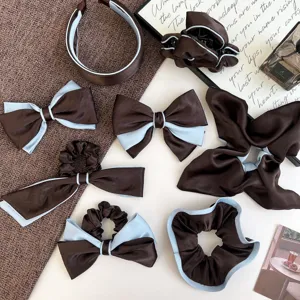 Detailed view of elegant brown and light blue satin bow hair clips and scrunchies set