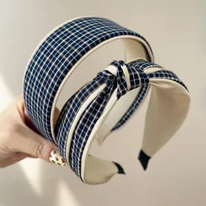 Detail of blue plaid knotted and wide-brimmed headbands with beige lining