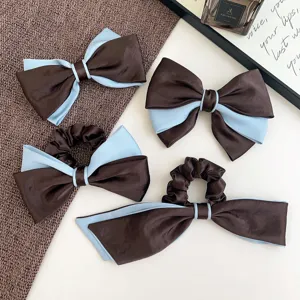 Detail view of elegant brown and light blue bow hair clips and scrunchies set