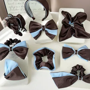Collection of elegant brown and light blue satin hair accessories on display blocks