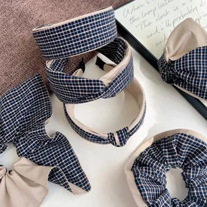 Detailed view of blue plaid hair accessories collection with knotted headbands and scrunchies.