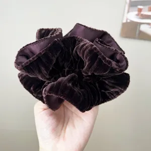 Detailed view of the soft velvet texture on a vintage dark burgundy oversized scrunchie