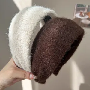 Détail de serre-têtes en laine duveteuse crème et marron pour la saison automne hiver