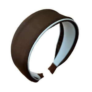 Elegant brown wide-brimmed headband with light blue lining, minimalist hair accessory.
