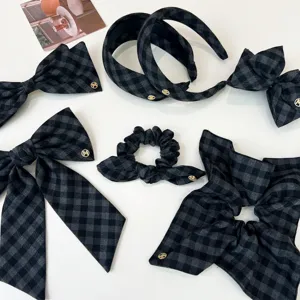 Detailed view of grey and black checkered hair accessories set featuring elegant gold accents