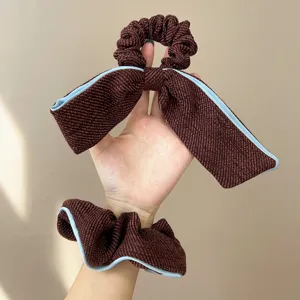 Elegant textured brown scrunchie hair tie set with large bow and light blue piping details