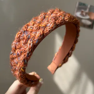 Detailed close-up showing the colorful braided yarn texture of this wide knitted headband