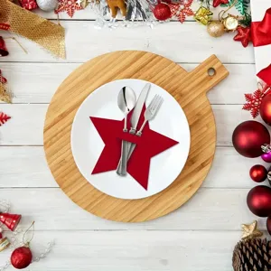 Festive red star-shaped Christmas felt cutlery holder displayed on a white ceramic plate