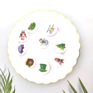 Detail view of cartoon enamel pin badges with diverse holiday and vehicle motifs on a plate