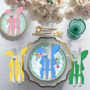 Table setting featuring colorful rabbit cutlery holders and elegant dinnerware for Easter