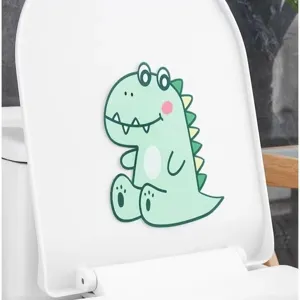 Detail of a cute green dinosaur felt deodorizing sticker applied on a white toilet lid