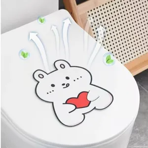 Detail view of a cute bear felt deodorant sticker applied to a toilet lid
