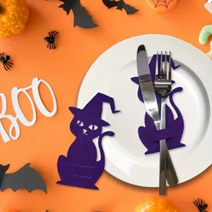 Detail of purple cat cutlery holder on a white plate for Halloween table decor