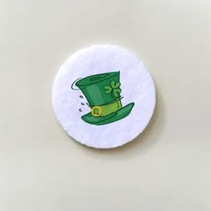 Detailed macro view of a cartoon green leprechaun hat with clover badge pattern