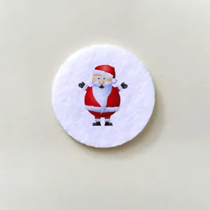 Detailed view of a circular Christmas brooch featuring a cartoon Santa Claus on felt.