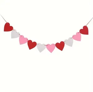 Beautiful detail of red white and pink heart felt banner garland for Valentine's Day wedding.