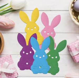 Set of colorful rabbit shaped paper cutlery holders for Easter holiday table decoration