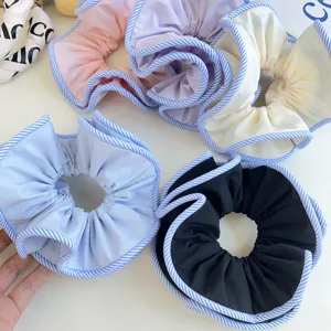 Assorted large fabric scrunchies with striped edges in a macro detail view.