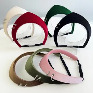 Detailed shot of various velvet headbands featuring vintage metal rings and adjustable straps.