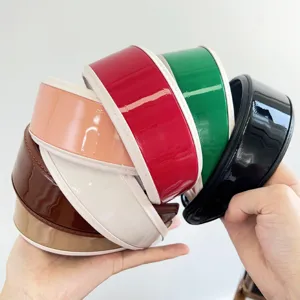Close-up detail of vintage glossy PU leather wide headbands in various colors for hair