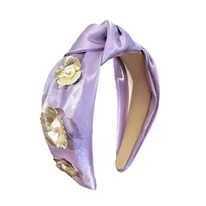 Elegant lavender satin knotted headband featuring 3D metallic flowers and white pearls