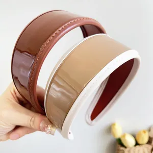 Detailed view of retro PU leather wide headbands with glossy finish and stitching