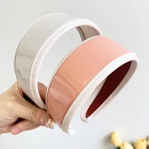 Close-up of retro PU leather wide headbands with elegant glossy finish in two colors