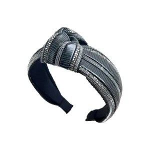 Elegante cerchietto annodato per donna con strass e design a tesa larga di colore nero.