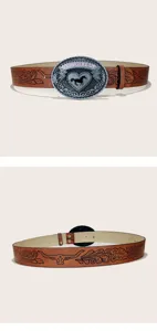 Ceinture en cuir marron style western avec grande boucle argentée et motif de tête de taureau.