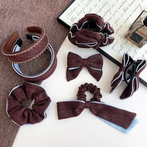 Detailed view of an elegant red tweed hair accessories set with light blue piping
