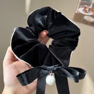 Elegant black velvet oversized scrunchie featuring a bow and white pearl pendant detail