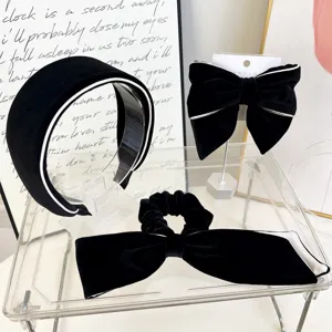 Set of black velvet hair accessories with white piping including headband and bows