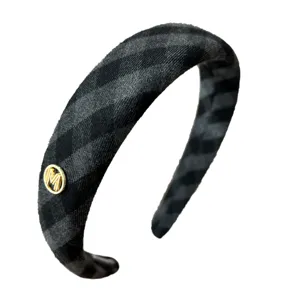 Vintage grey and black checkered padded sponge headband with decorative gold M logo