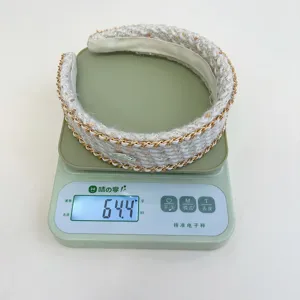 Close-up detail of a white tweed woven headband on a scale showing 64.4g weight.