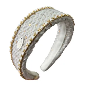 Elegant white knitted headband with gold chain trim and subtle sequins for women
