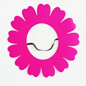 Close-up detail of vibrant pink felt sunflower headpiece prop for performance events