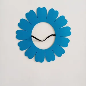 Close-up view of a blue felt sunflower headpiece for kids performance with elastic strap