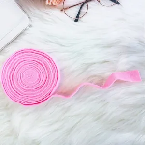 Close-up view of a vibrant pink felt ribbon roll for DIY Christmas wreaths and bows
